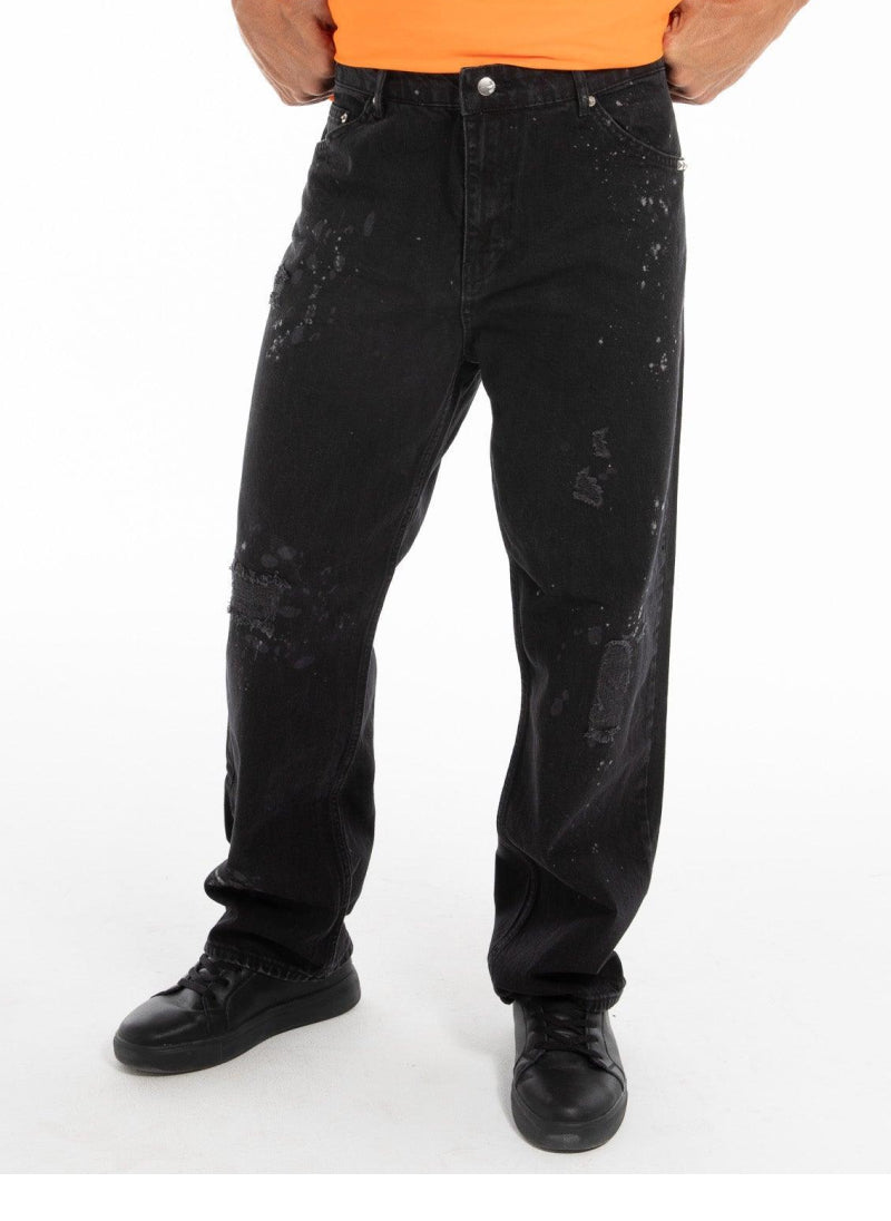 Black jeans with chain details along the side, showcasing a modern fit and urban style.