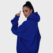 Flashmob Nation blue oversized "FM" signature hoodie and jogger set – front view highlighting relaxed streetwear fit and minimalist branding.