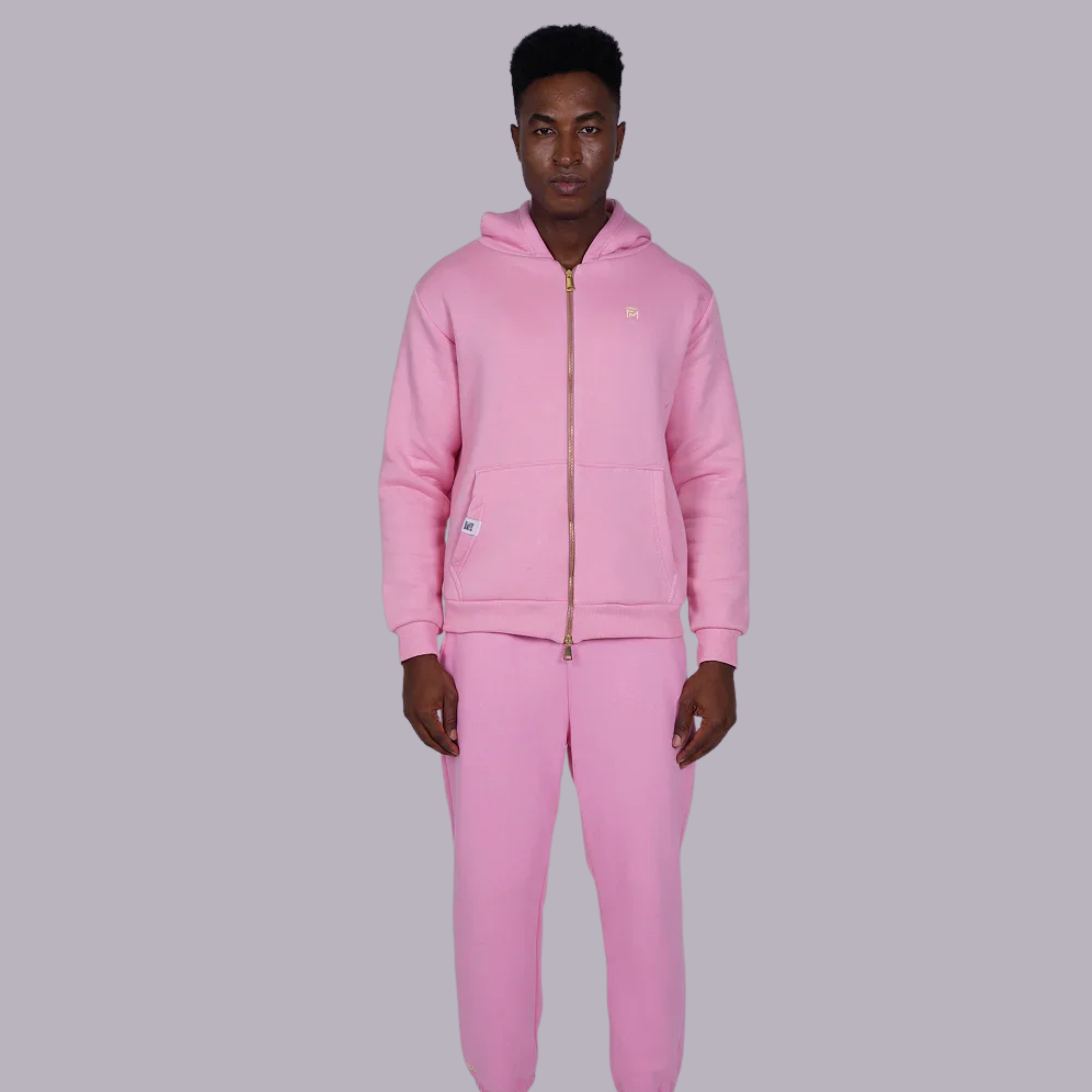 Person wearing a pink tracksuit on a gray background