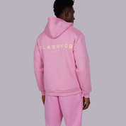 Person wearing a pink hoodie with 'FLASHMOB' text on the back against a gray background