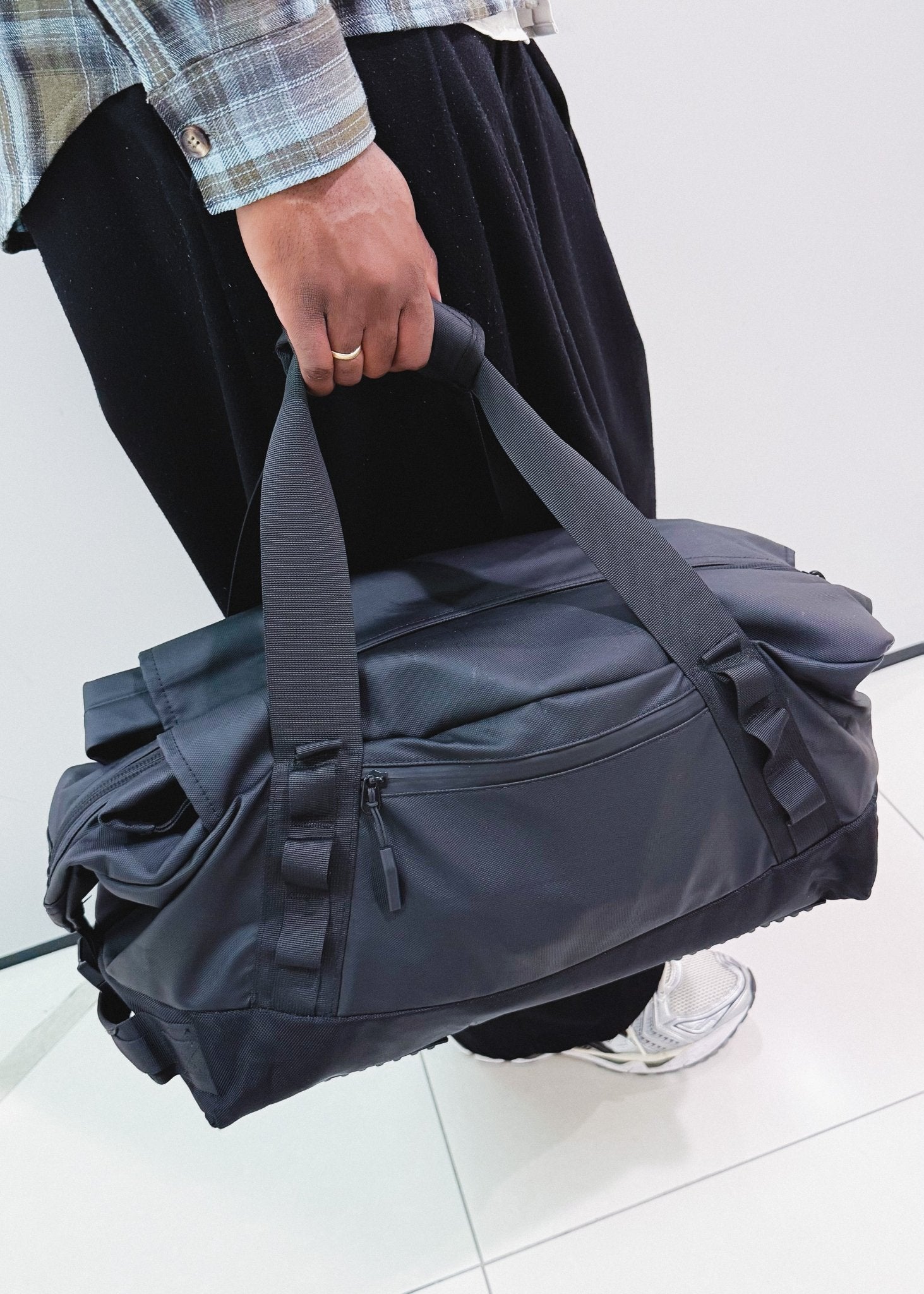 Close-up of black multi-functional duffel bag with durable handles - Flashmob Nation