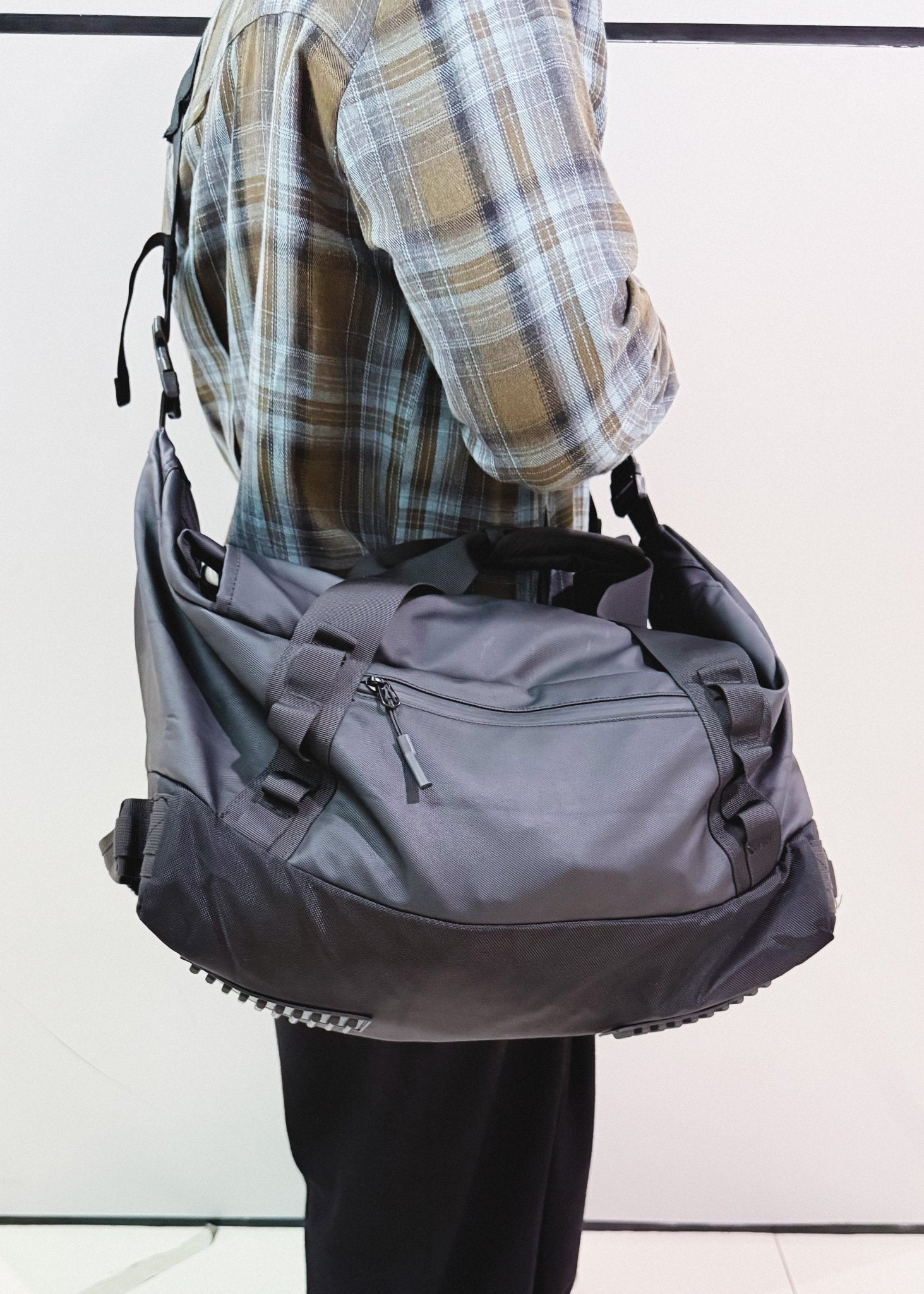 Adjustable black crossbody travel bag worn over the shoulder - Flashmob Nation