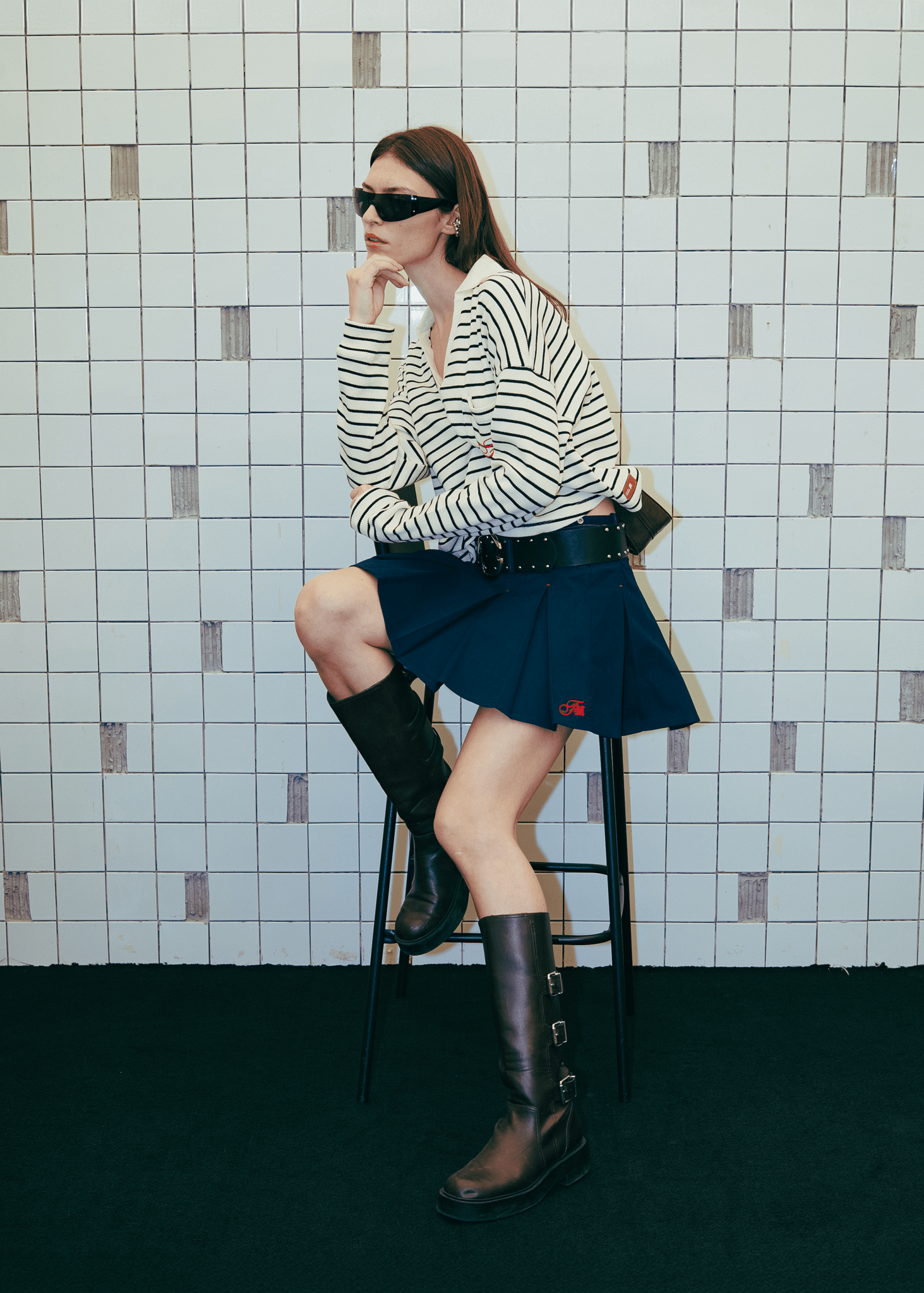 Urban lifestyle look featuring the Clove Pleated Bowling Skirt sitting on chair