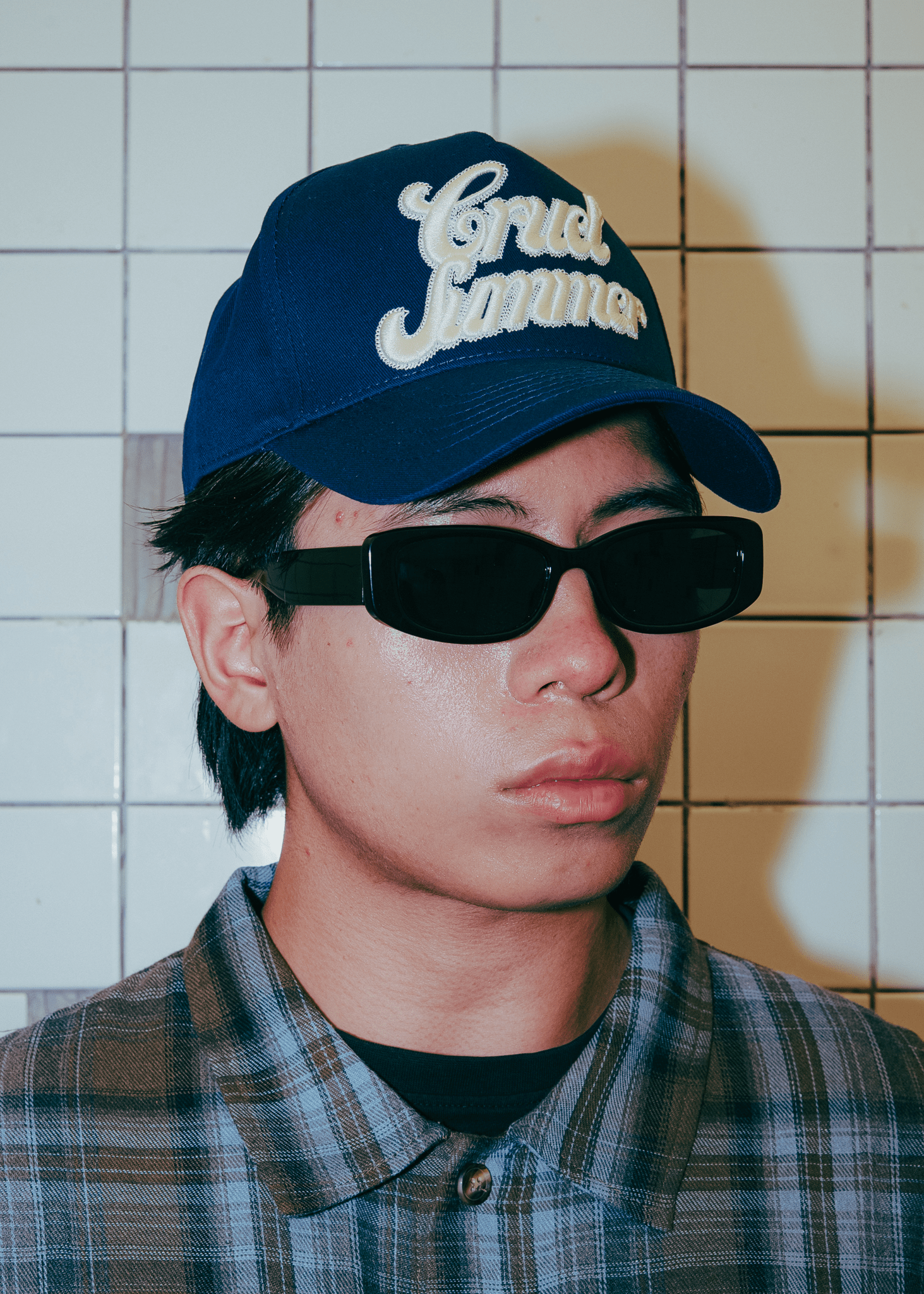 Model Wearing Navy blue cotton-twill Summer Cap with Cruel Summer script embroidery.