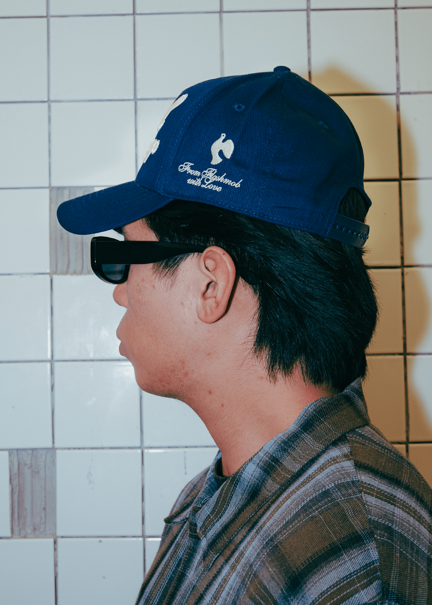 Profile view of the structured navy blue Cruel Summer cap showing the twill texture.