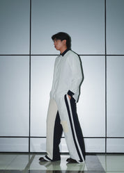 Men's urban outfit featuring structured panel poplin trousers and technical shirt.