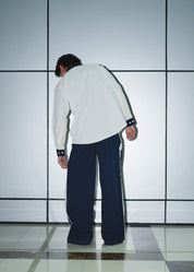 Rear profile of the poplin trousers highlighting the straight-leg fit and pocket placement.