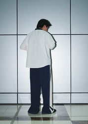 Back view of the men’s white poplin overshirt showing the structured athletic fit.