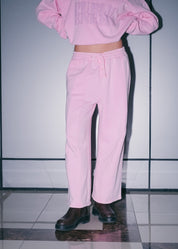 Women's streetwear outfit featuring Pink Relaxed Sweatpants and a matching signature hoodie.
