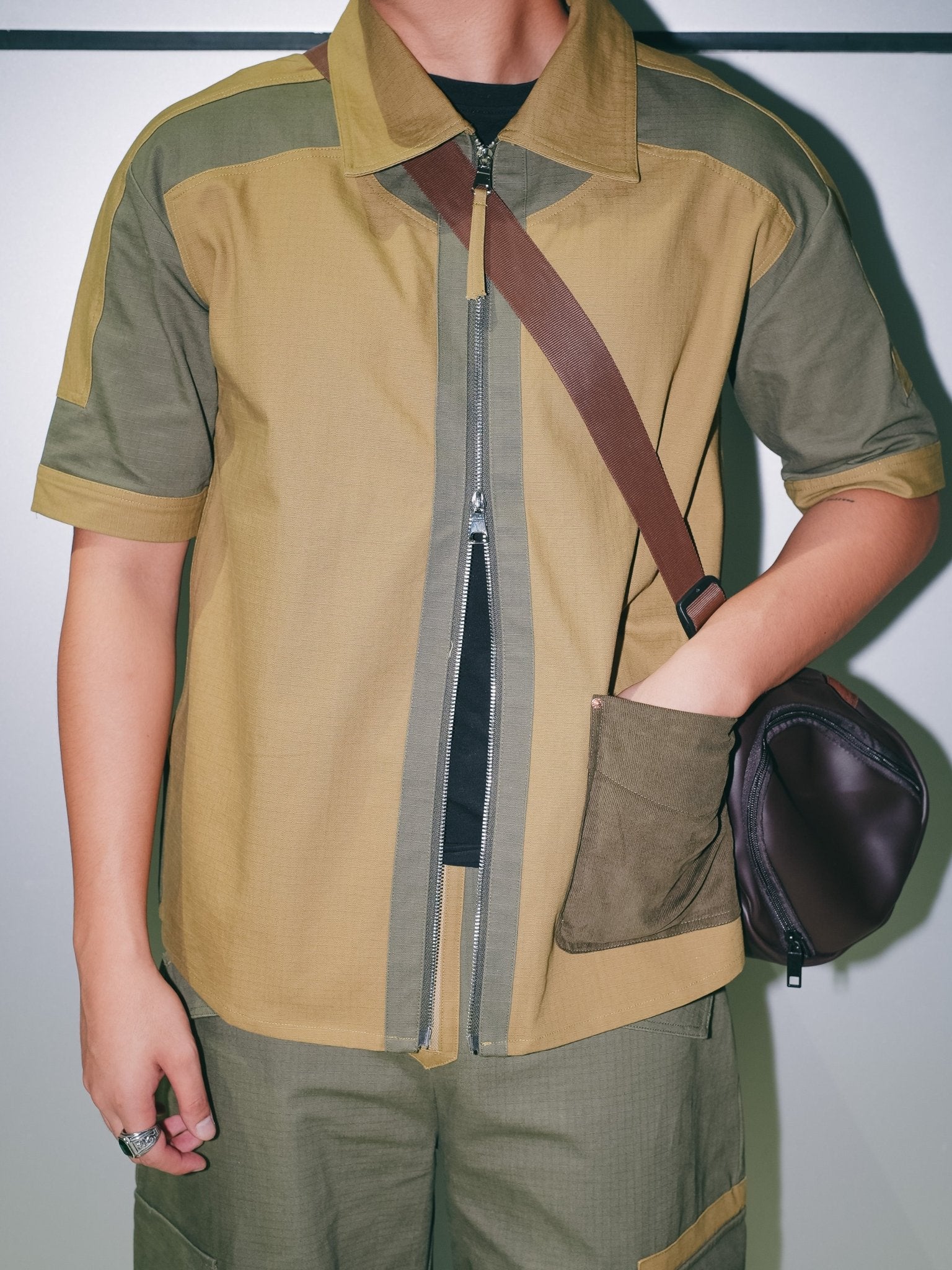 Men's short-sleeve tech utility shirt featuring a two-tone industrial design.