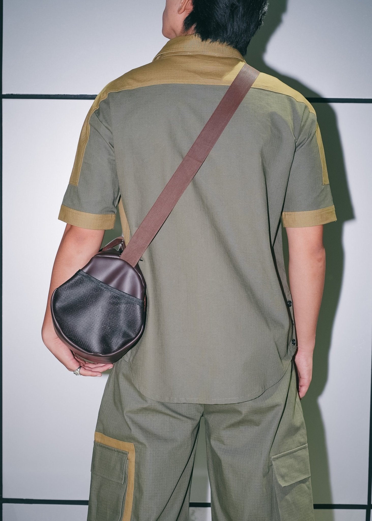 Rear view of the two-tone utility zip shirt showing the structured paneled back.