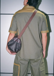 Rear view of the two-tone utility zip shirt showing the structured paneled back.