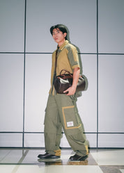 Full streetwear look featuring olive green technical cargo pants and matching shirt.