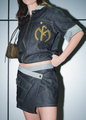 Women's industrial streetwear set featuring the navy asymmetric skirt and zip top.