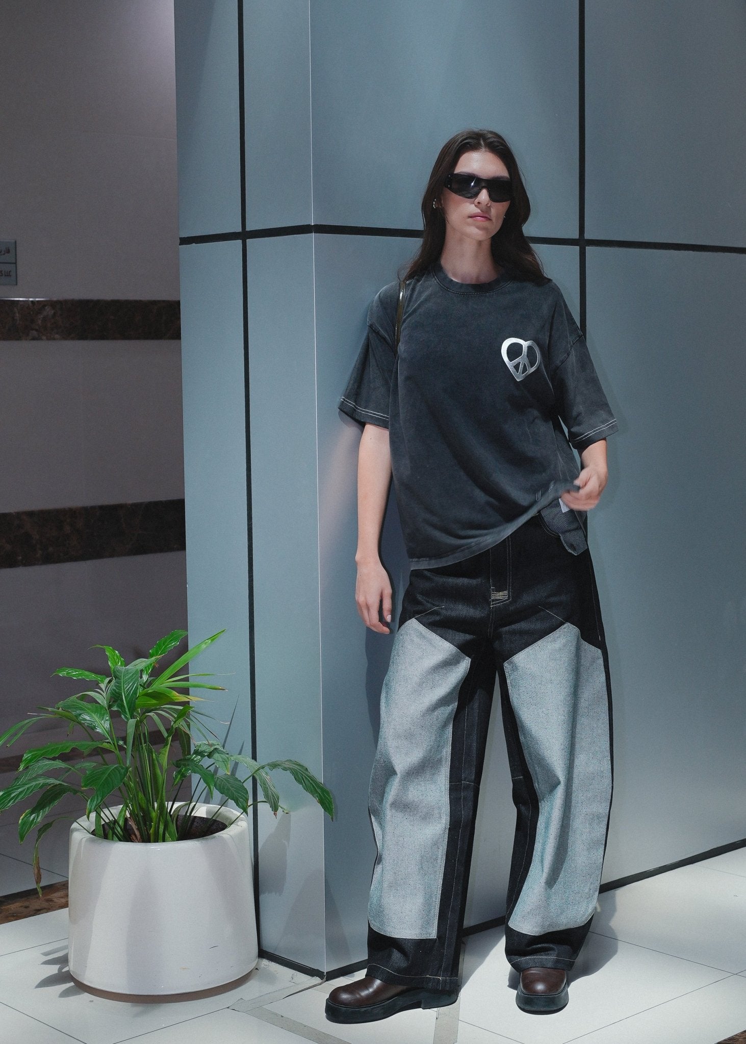 Urban streetwear outfit featuring sculptural rounded denim jeans and a boxy top.