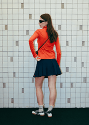 Rear view of the women's slim-fit long-sleeve polo on model